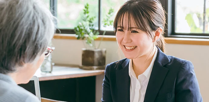 バイセルの女性査定士がお客様と話している写真